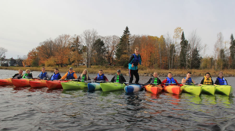 This page includes links to coach applications and interschoolastic handbook.  The image is of RLRS Senior kayak trip.
