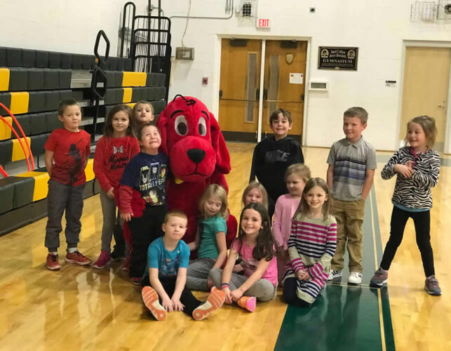 Elementary school students with Clifford the Big Red Dog.