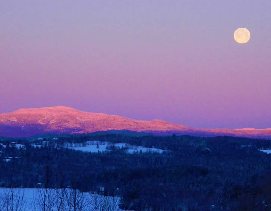 Social worker contact information.  Image depicts a full moon over Rangeley Lake.